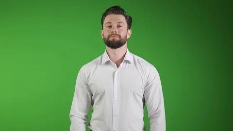 Charming handsome. Handsome young man in casual wear keeping arms crossed and Stock Footage 114577791