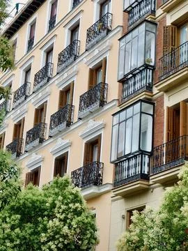 Charming historic building featuring multiple balconies adorned with iron r.. Stock Photos
