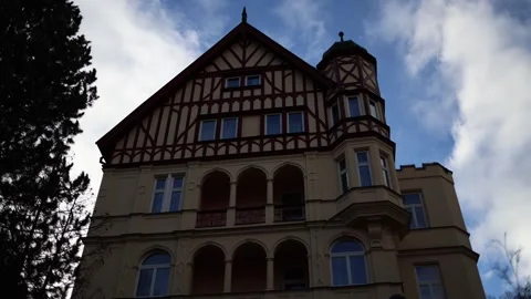 A charming historic building with half-timbered details and arched windows stand Stock Footage 300540934