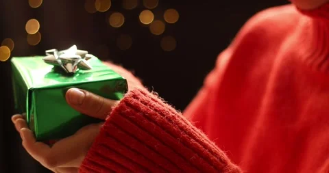 Charming holiday gift presentation with warm, festive lighting Stock Footage 339072110