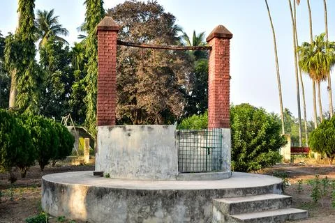This charming image captures a quaint old well nestled in a serene garden. Stock Photos