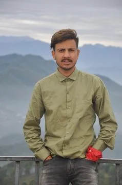 A charming Indian young guy looking at camera with hands in pocket  Stock Photos