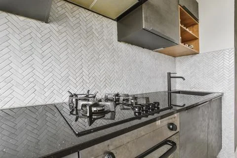 Charming kitchen area with a black kitchen set Stock Photos
