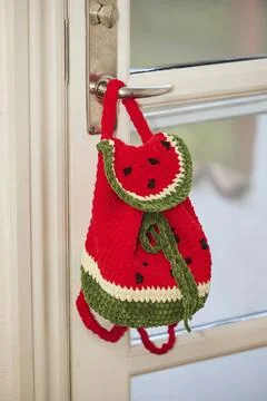 Charming knitted backpack in the shape of a watermelon Stock Photos
