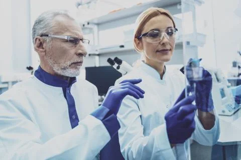 Charming lab assistant working at project Stock Photos