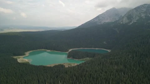A charming lake surrounded by forests in the mountains of northern Montenegro Stock Footage 293099438