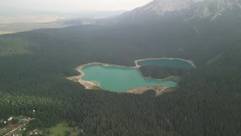 A charming lake surrounded by forests in the mountains of northern Montenegro Stock Footage 293099472
