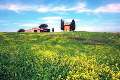 Charming landscape with chapel of Madonna di Vitaleta among the rape fields o Stock Photos