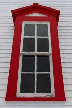Charming lighthouse window with bright red frame Stock Photos