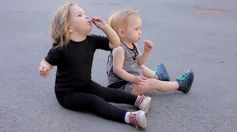 Charming Lovely Sisters Happy to Eats Ice Cream With Joy Then Get up and go Out Stock Footage 66549141