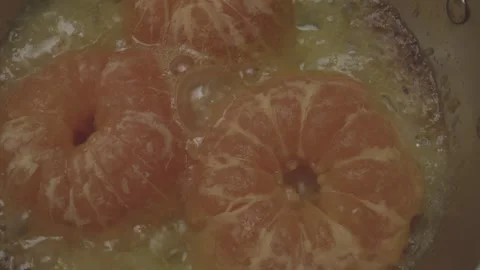 In a charming miniature kitchen tiny cookware sizzles as circular citrus fruits Video stock 286902256