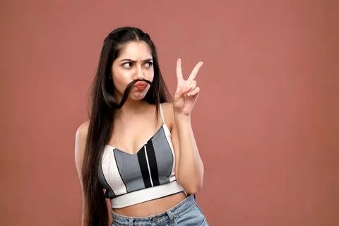 A Charming Model Making Curls Fake Mustache Looking Far Away Stock Photos