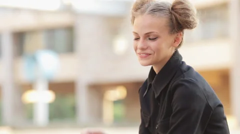 Charming model posing for the camera while sitting near the University Stock Footage 52923484