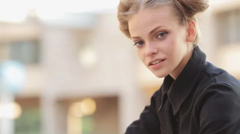 Charming model posing for the camera while sitting near the University Stock Footage 52923486