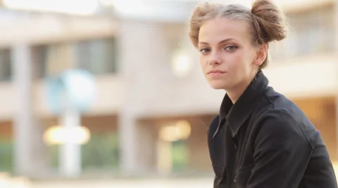 Charming model posing for the camera while sitting near the University Stock Footage 52923521