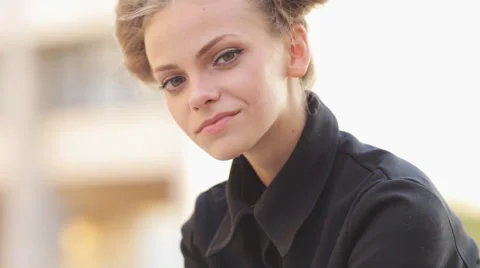 Charming model posing for the camera while sitting near the University Stock Footage 52923813