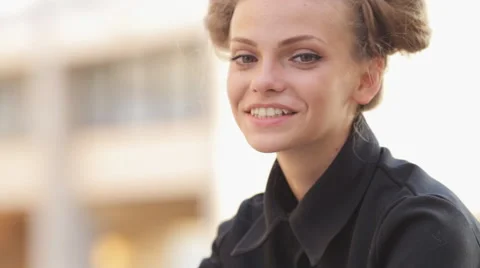 Charming model posing for the camera while sitting near the University Stock Footage 52923861