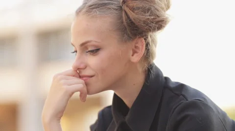 Charming model posing for the camera while sitting near the University Video stock 52924028