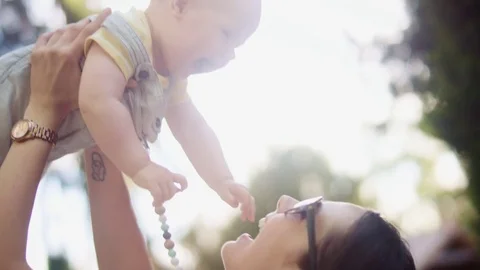 Charming mother carrying her beloved son Stock Footage