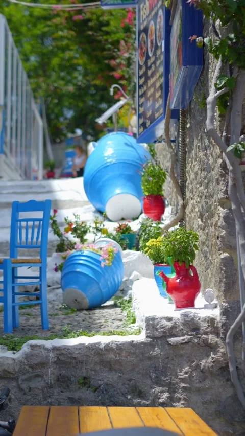 Charming narrow stone steps with blue chairs and white accents in Kos, Gree.. Stock Footage 290098819