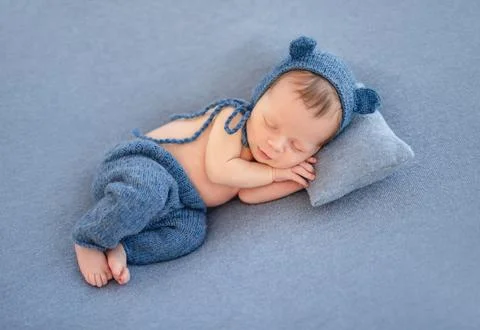 Charming newborn in cute hat Stock Photos