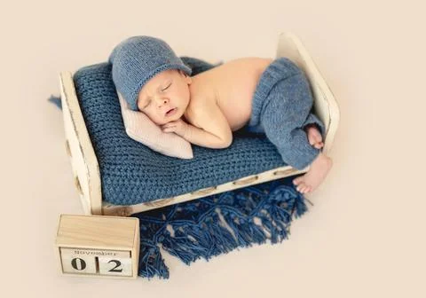 Charming newborn in cute hat Stock Photos