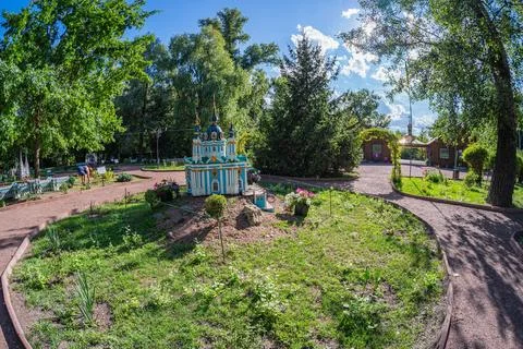 A charming octagonal gazebo with a central dome, possibly white, in a well-ma Stock Photos