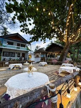 Charming Outdoor Cafe with String Lights in Tropical Setting Stock Photos