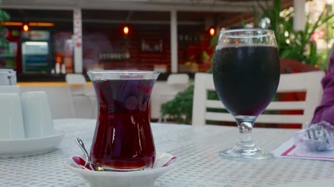 Charming outdoor scene featuring Turkish tea and dark soda drinks Video stock 331556826