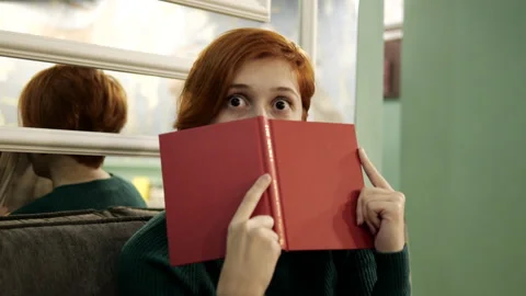 Charming person reading book closeup red hair. Female leisure in pages novel 4K Stock Footage 159994643