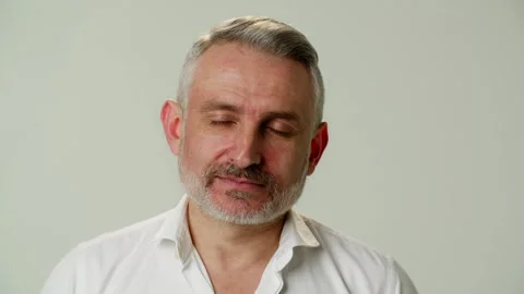 A charming, positive middle aged man looks at interlocutor and listens Video stock 252880485