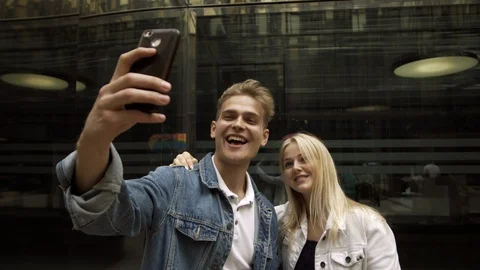 Charming positive young guy and a beautiful blonde girl take a selfie Stock Footage 114455583
