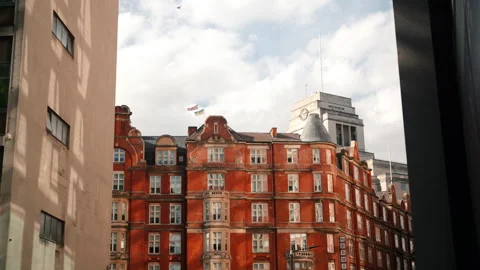 A Charming Red Brick Building Beautifully Stands Out Against the Expansive Sky Video stock 293677598