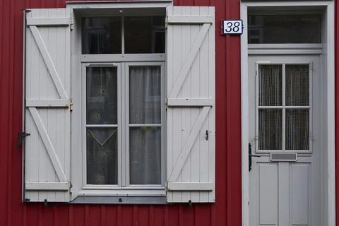 Charming Red House Featuring Beautiful Window and Door Details that Capture.. Stock Photos