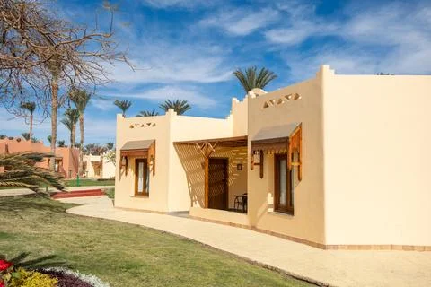 Charming resort accommodations in Egypt with palm trees and blue skies Stock Photos