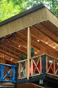 Charming rustic balcony seating area with wooden railings and straw Stock Photos