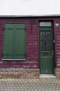 Charming Rustic Door with Shuttered Windows Displaying a Variety of Vibrant.. Stock Photos