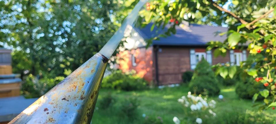 A Charming Rustic Garden View Featuring A Tool That Is In Clear Focus and Detail Stock Photos