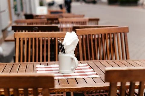 A charming rustic outdoor dining setup featuring a wooden table with a checkered Stock Photos