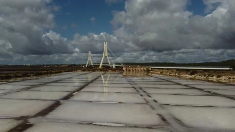 Charming salt fields on river Arade in Portimão with reflection of bridge Nova Stock Footage 140460059
