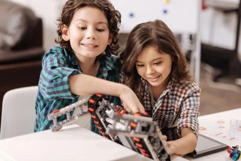 Charming school children programming devices in the science studio Stock-Fotos