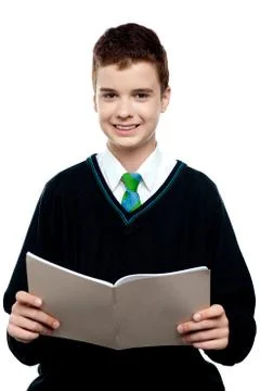 Charming schoolboy holding workbook Stock Photos