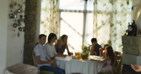 Charming senior woman posing on the camera and family sitting at dinning table Stock Footage 66289830