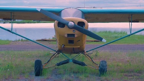 Charming Single Engine Aircraft in Small Alaskan Airstrip at Sunrise Stock Footage 83119660