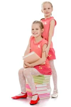Charming sisters with books Stock Photos