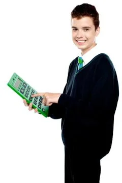 Charming smiling school kid operating calculator Stock Photos