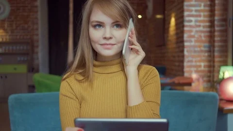 Charming smiling woman having talking conversation on mobile phone while sitting Stock Footage 72118786