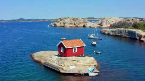 Charming summer cottage house or cabin in Norwegian fjord. Small rocky island Stock Footage 320498600