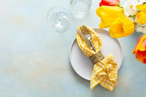 A charming table setting for spring includes a white plate with a yellow ch.. Stock Photos