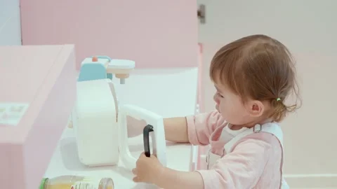 Charming Toddler Is Playing With A Microwave Oven Toy Inside The Kids Stock Footage